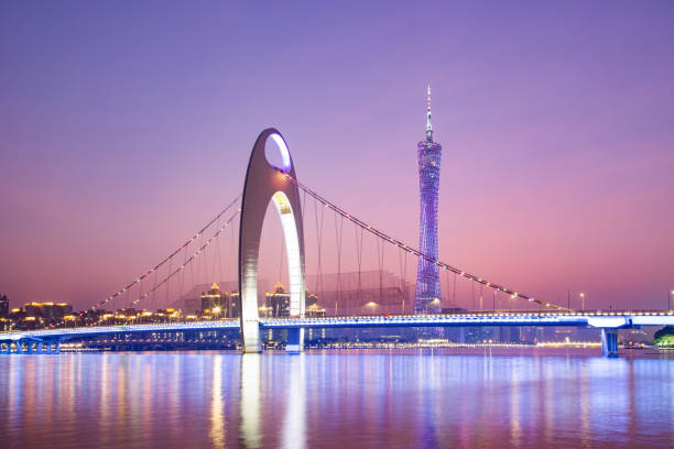 istock modern suspension bridge over river at sunset 899823226