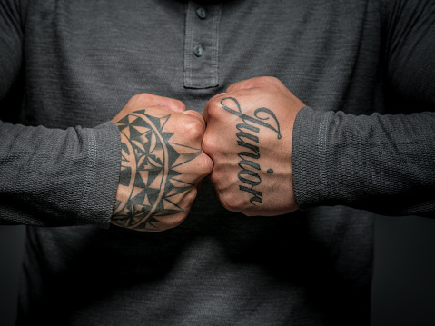 Close-up on a MAori man shoing the tattos in his hands