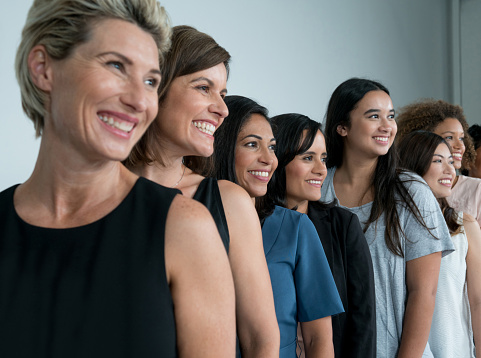 Large group of multi-ethnic women in a studio and smiling