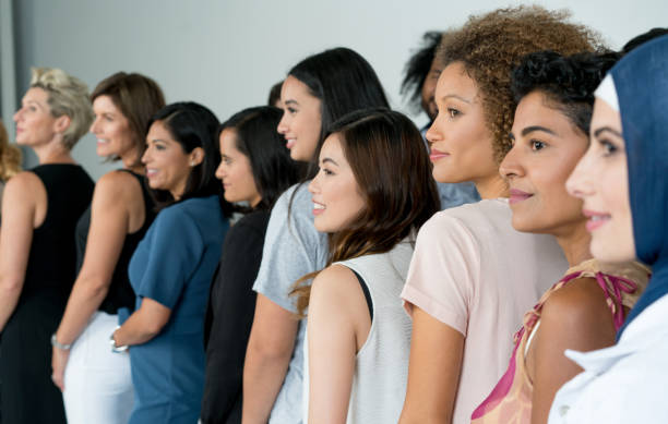 Large group of multi-ethnic women smiling Large group of multi-ethnic women posing at a studio and smiling mixed age range stock pictures, royalty-free photos & images
