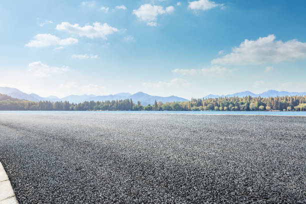 istock asphalt road and lake with mountain landscape 899831598