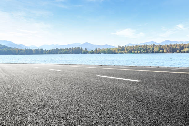 istock asphalt road and lake with mountain landscape 899831728