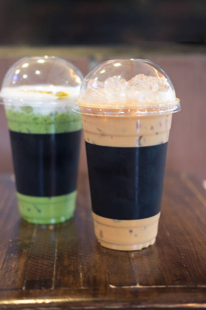 istock Ice coffee and green tea on wood table 899835996