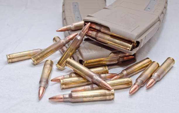 istock Two .223 rifle magazines with bullets laying next to them 899840720