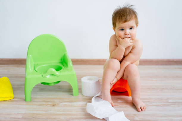 istock Baby sitting on a potty 899843836