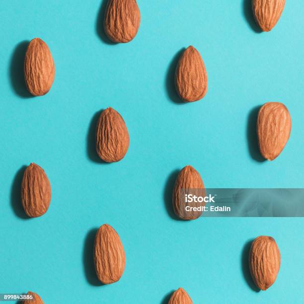 Symmetrical Pattern Of Almonds On Blue Flat Lay Stock Photo - Download Image Now - Almond, Backgrounds, Pattern