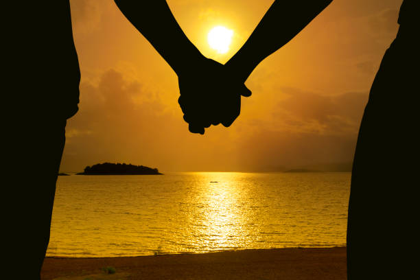 istock Couple holding hands and beautiful sunset 899843944