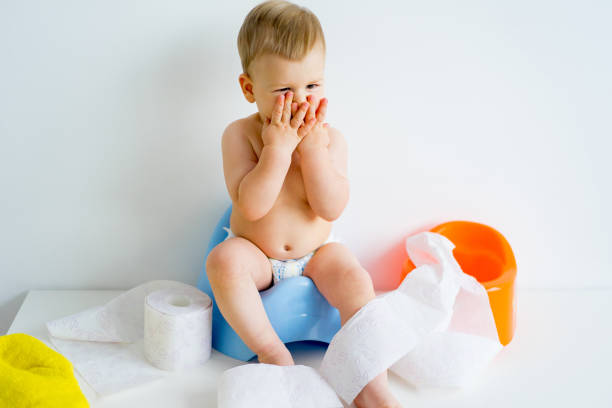 Baby sitting on a potty Cute smiling baby sitting on the potty potty toilet child bathroom stock pictures, royalty-free photos & images