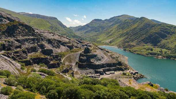 View from Dinorwic Quarry, Wales, UK View from Dinorwic Quarry, near Llanberis, Gwynedd, Wales, UK - with Llyn Peris, the Dinorwig Power Station Facilities and Mount Snowdon in the background mount snowdon photos stock pictures, royalty-free photos & images