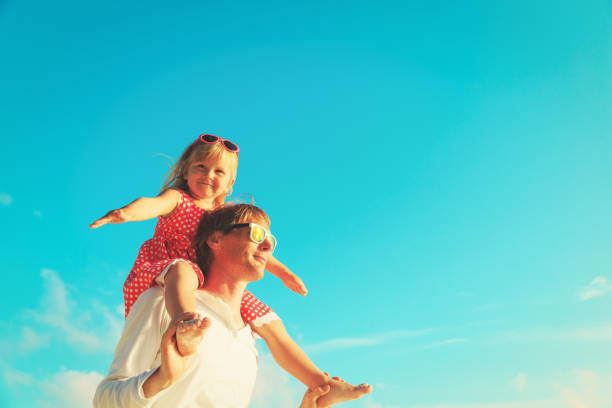 istock father and little daughter play at sky 899854028