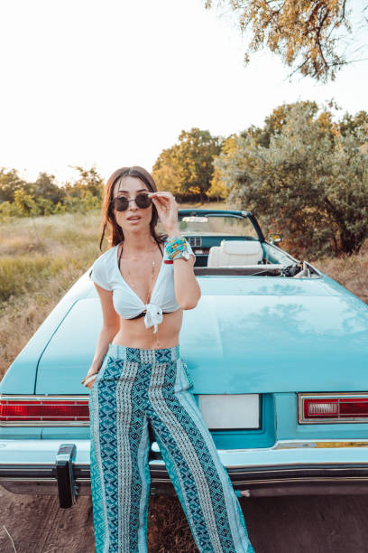 istock Girl posing on a background cabriolet 899854080