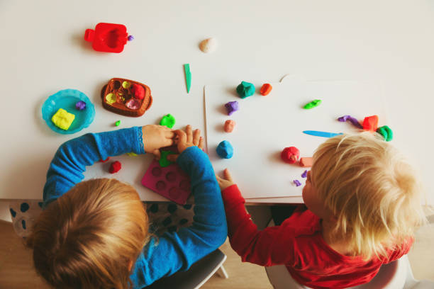 istock kids play with clay molding shapes 899854682