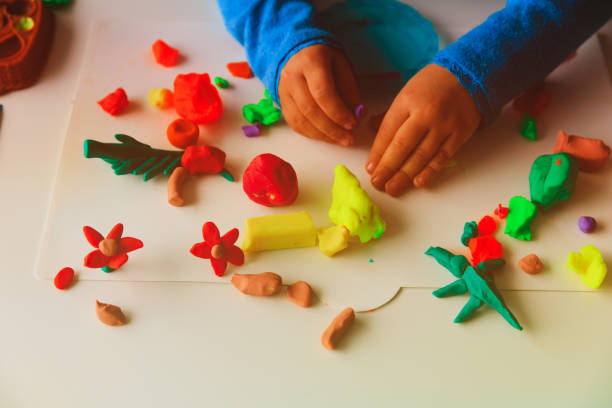istock Child playing with clay molding shapes 899854728