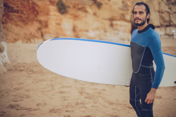 istock Cute surfer on the beach 899857390