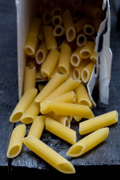 istock Penne noodle on dark rustic wood 899865182