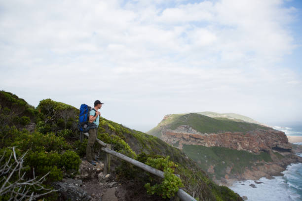 istock Man admires the amazing view on a hike 899874346