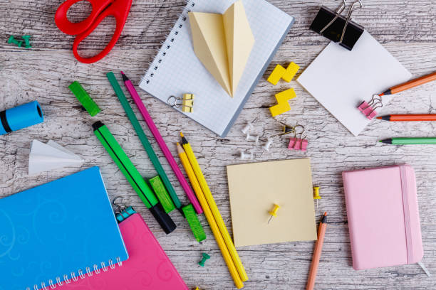 istock Various stationery, notebooks and clips, on a wooden background. Top view. 899881806