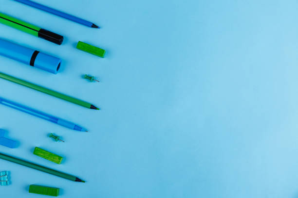 istock Pens, pencils, markers, clips and crayons, layout on a blue background with a place for writing. View from above. 899882108