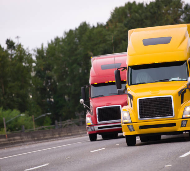 istock Two big rig semi trucks running side by side on the road 899888310