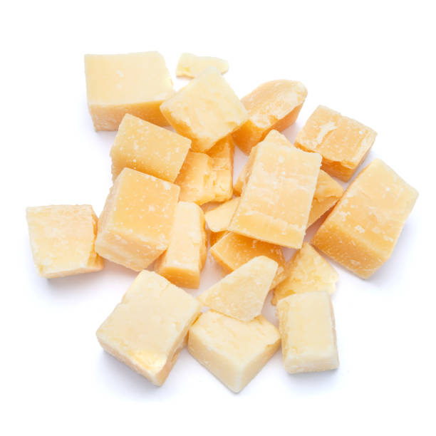 istock Small pieces of parmesan cheese on white background 899888960