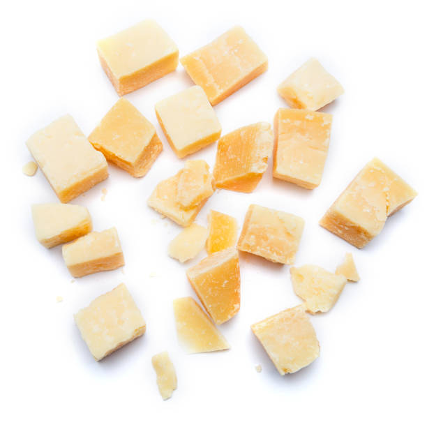 istock Small pieces of parmesan cheese on white background 899889084