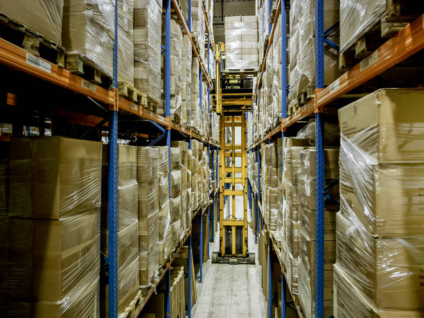 istock Truck placing pallet on rack in warehouse aisle 899889582
