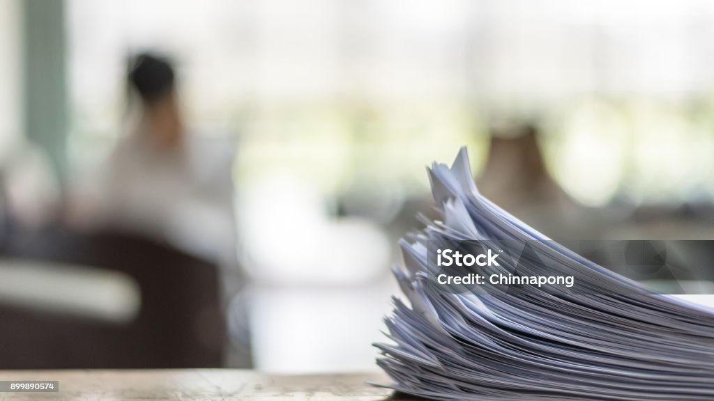 Exam Answer sheet in exam room Exam answer sheet or application paper blurry view on table in examination room with blur education background of school university students taking exam test writing answer in seat row with stress Educational Exam Stock Photo