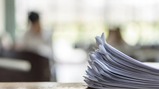 Exam Answer sheet in exam room Exam answer sheet or application paper blurry view on table in examination room with blur education background of school university students taking exam test writing answer in seat row with stress form submission stock pictures, royalty-free photos & images