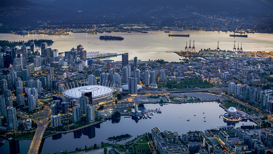 Exterior of BC Place and Science World with modern cityscape and harbour, Vancouver, British, Columbia, Canada.
