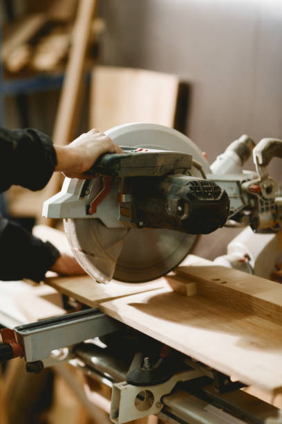 istock The man is a carpenter holds a hand grip with a metal lathe with a sharp round knife for cutting wood. 899897980