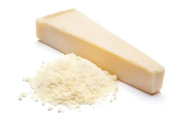 a piece of italian Parmesan and grated cheese on white background