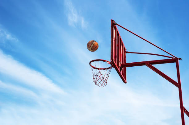 istock Old Basketball ring on blue sky 899910832