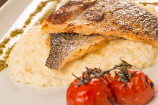 istock Grilled trout with risotto, tomatoes, and pesto 899913762