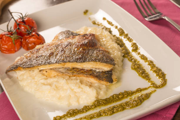 istock Grilled trout with risotto, tomatoes, and pesto 899913788