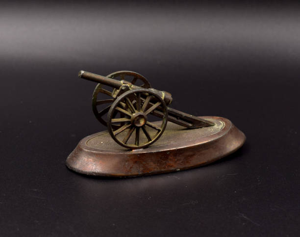 istock Bronze Toy Cannons on Black 899914078