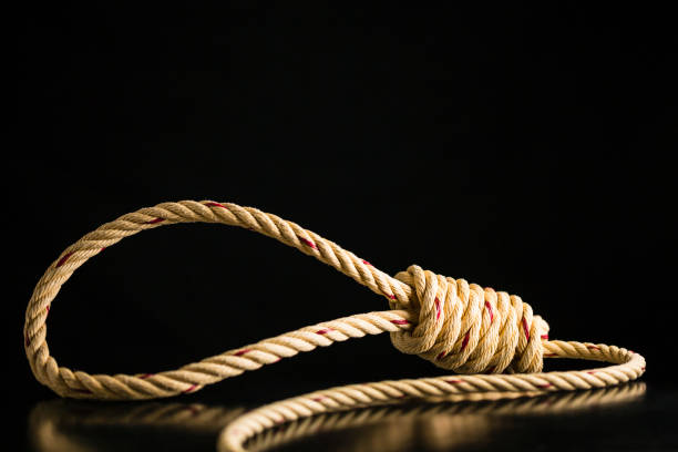 istock Brown rope noose dark and light on black table with black background 899914206