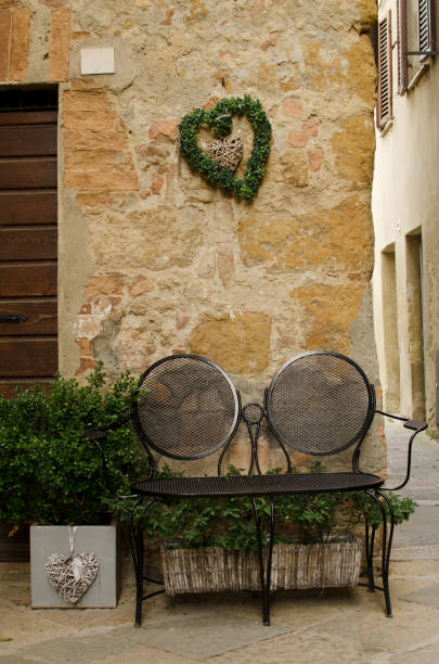 istock Metal romantic bench for two near the wall 899918010