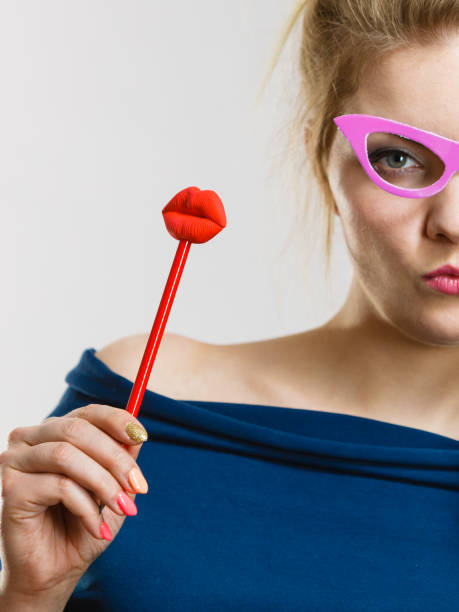 istock woman holds carnival accessories on stick 899918074