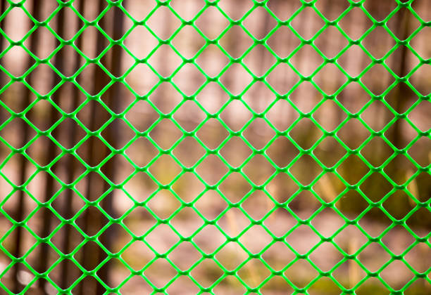istock Green grid on the fence as a background 899921664