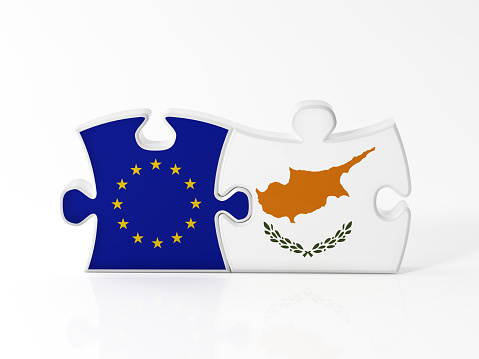 Jigsaw puzzle pieces textured with European Union and Cypriot flags on white. Horizontal composition with copy space. Clipping path is included.