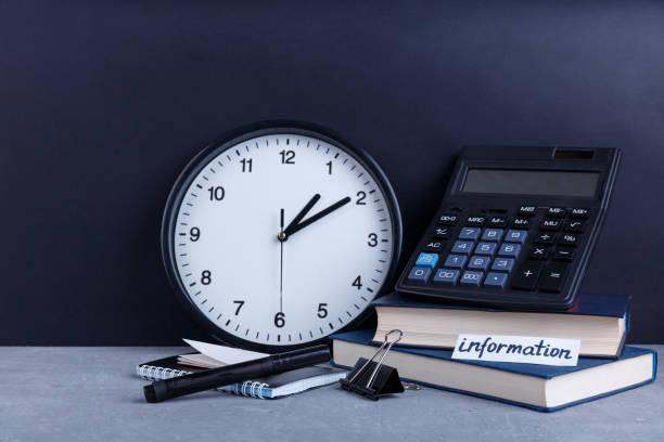 istock On the table is inscription Information, next to a watch, several books, a calculator, a notepad and a clip. 899923428