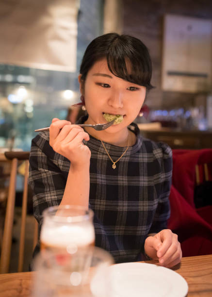 istock Young woman eating appetizer at restaurant 899926214