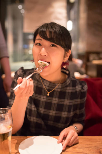istock Young woman having dinner at restaurant 899926266