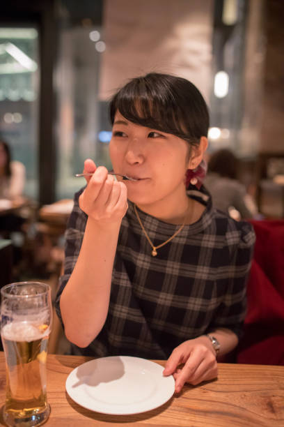 istock Young woman having dinner at restaurant 899926280