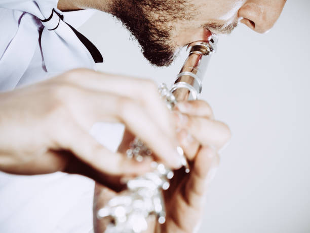 istock Male flutist playing his flute closeup 899931684