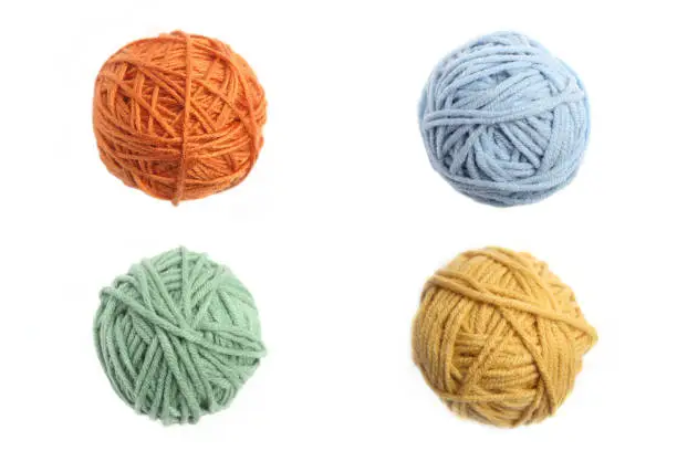 Set of four color (orange, yellow, green, blue) thread balls.