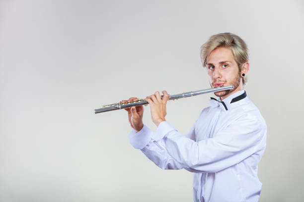 istock Male flutist playing his flute 899935142