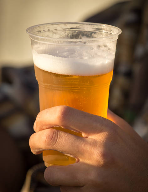 istock Fresh beer in a plastic cup in the hand 899938914