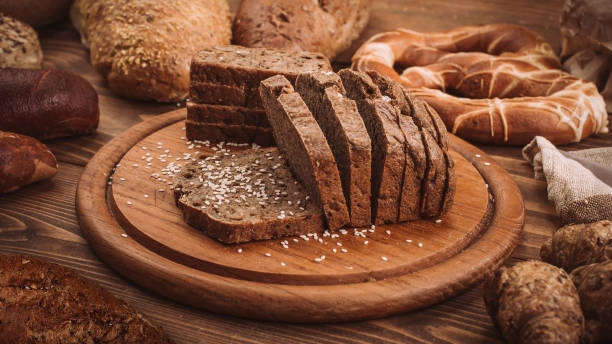 istock Various baked breads and rolls on rustic wooden table 899946948