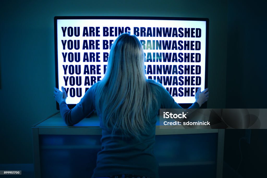 Woman Being Brainwashed By Television A woman stares at her television set as she is being brainwashed by it. Television Set Stock Photo